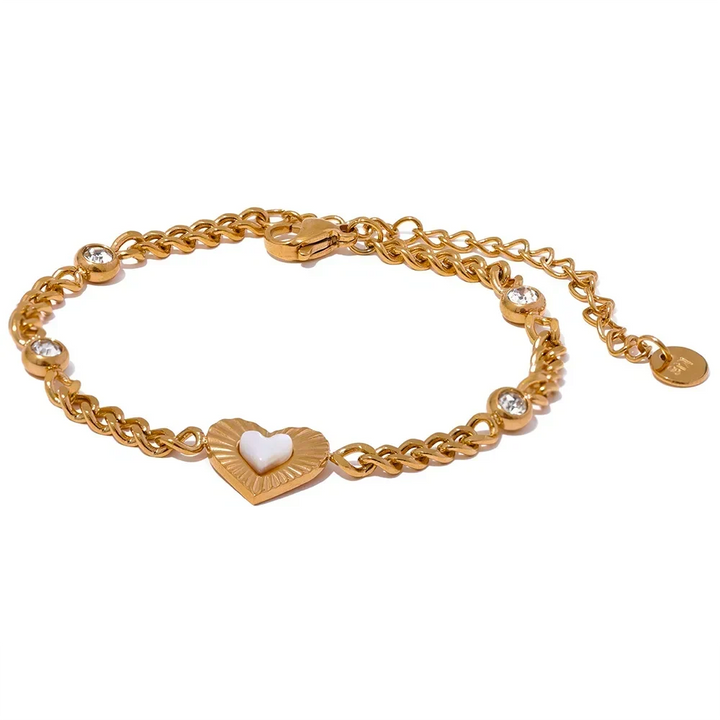 Gold bracelet with a heart-shaped charm on a white background