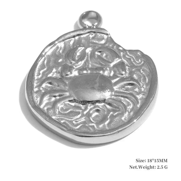 Silver pendant with intricate design on a white background