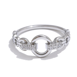 Silver ring with interlocking design and embedded diamonds on a white background