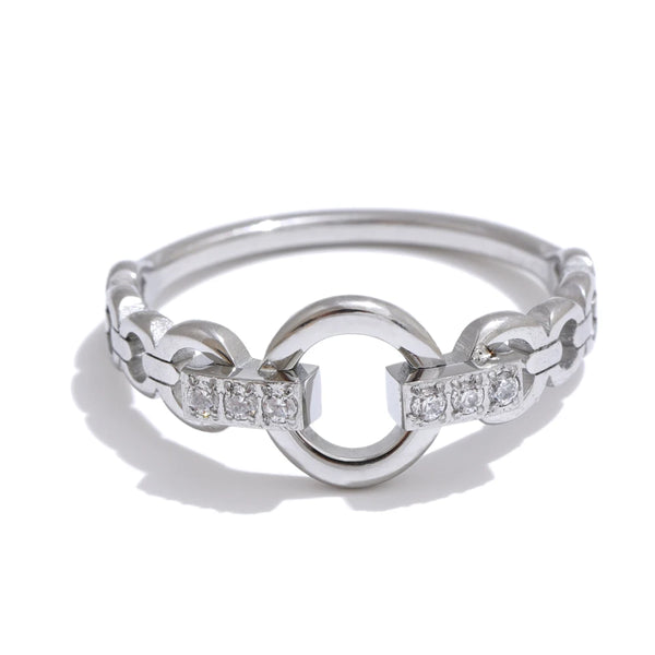 Silver ring with interlocking design and embedded diamonds on a white background