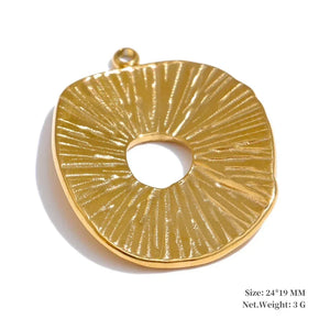 Gold pendant with textured design on a white background