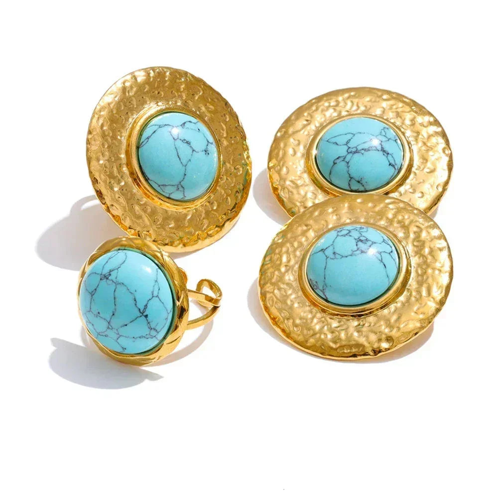 Gold earrings with turquoise stones on a white background.