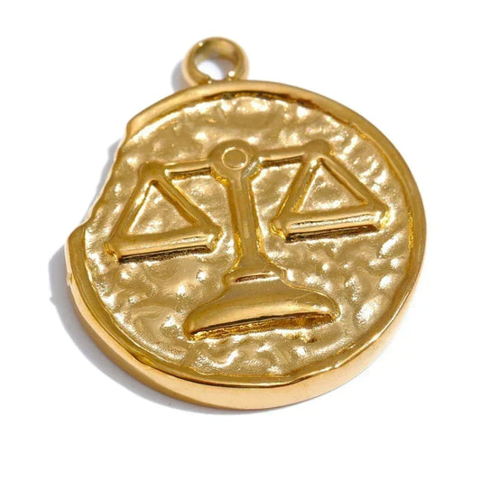 Gold pendant with a scale design on a white background