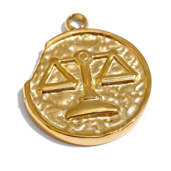 Gold pendant with a scale design on a white background