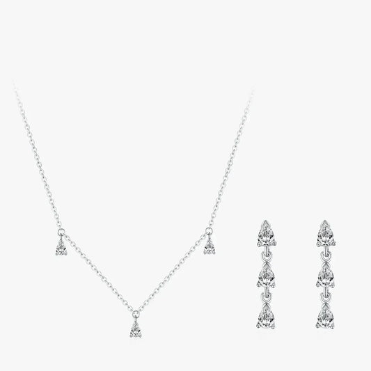 Silver necklace and earrings set on a white background