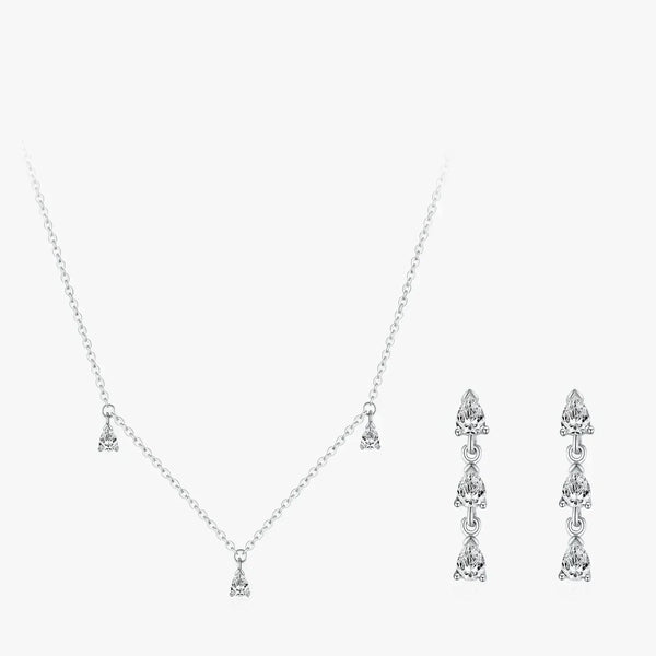 Silver necklace and earrings set on a white background