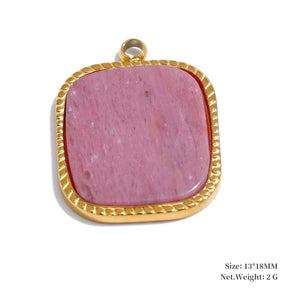 Pink stone pendant with gold frame on a white background