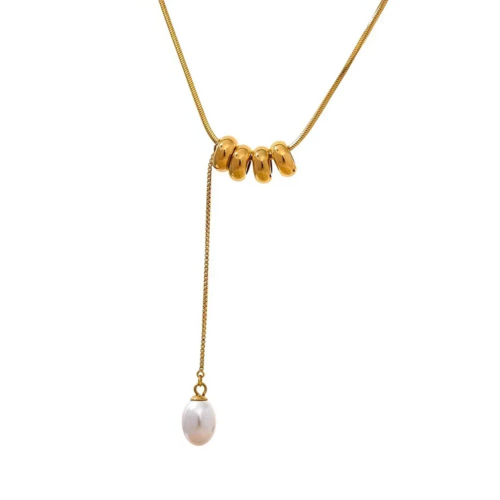 Gold necklace with three beads and a pearl pendant on a white background
