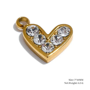 Gold heart-shaped pendant with clear stones on a white background