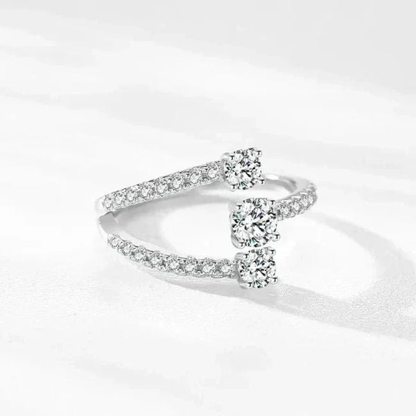 Sterling silver open ring with three round-cut cubic zirconia and pavé band accents
