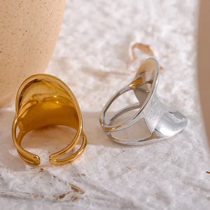 Modern wide band 18K gold-plated ring with unique open design on white background