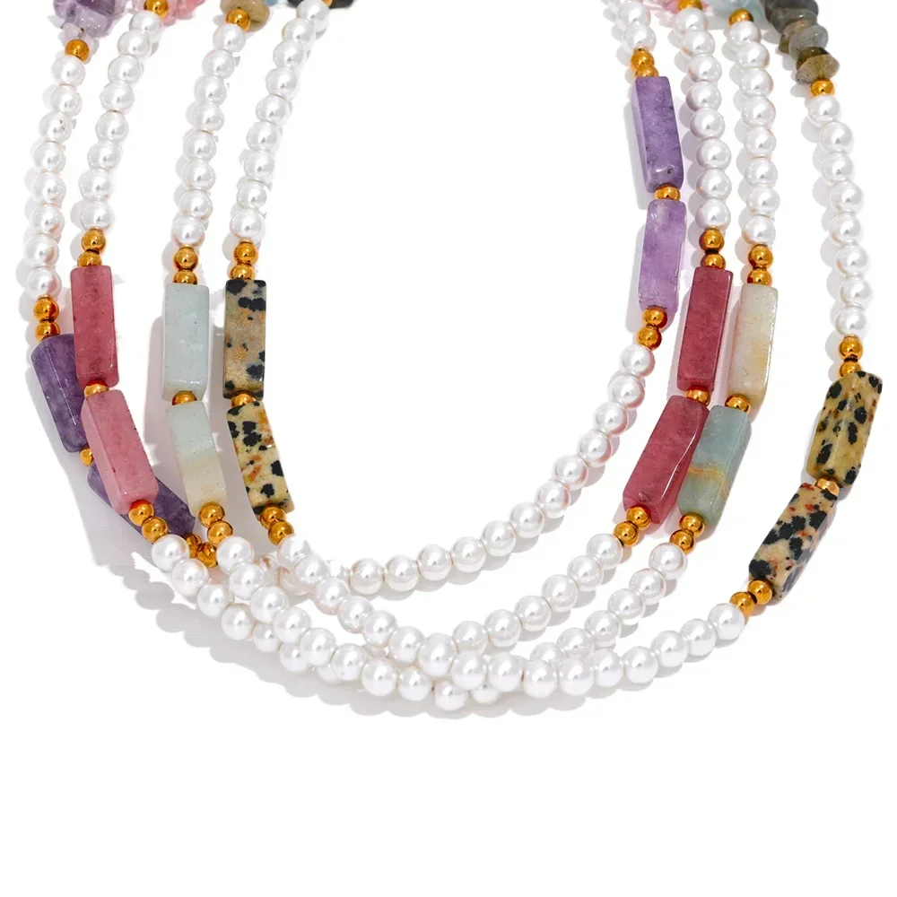 Necklace with pearls and multicolored beads on a white background.