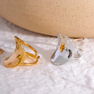 Modern wide band 18K gold-plated ring with unique open design on white background