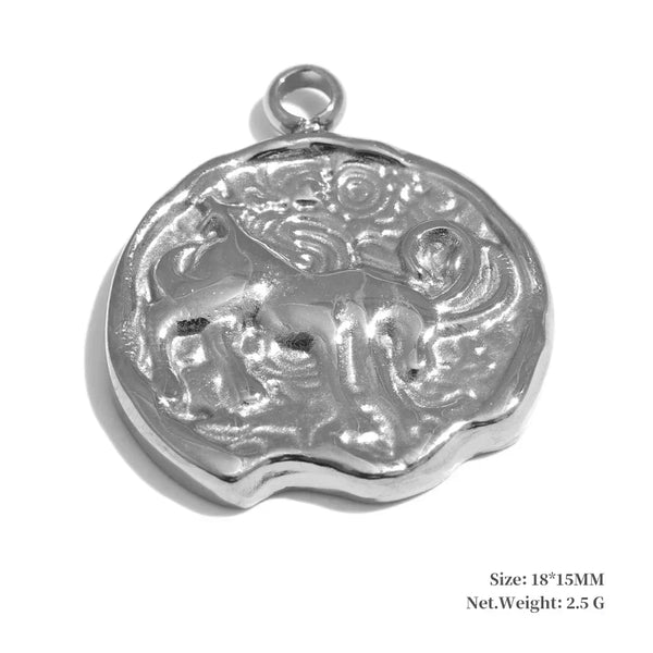 Silver pendant with intricate design on a white background