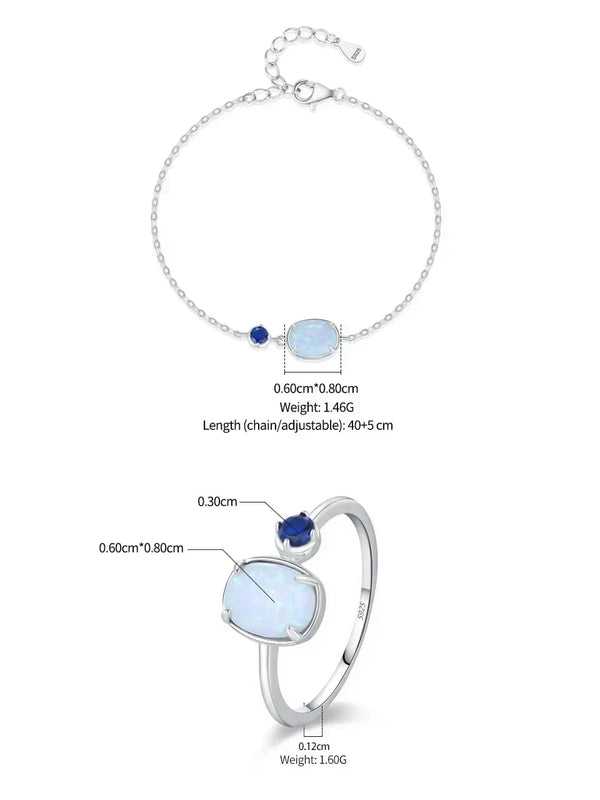 Silver chain bracelet and matching ring set with a large iridescent white opal-like stone, a small deep blue gemstone, and adjustable chain details, shown with measurement annotations on a white background.