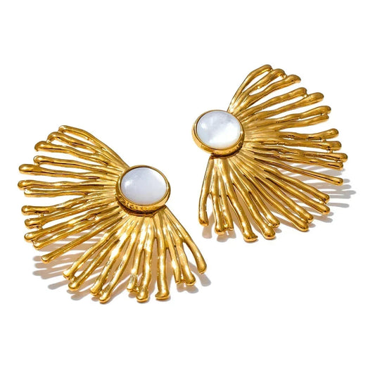 Gold earrings with white stones on a white background