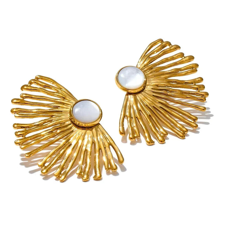 Gold earrings with white stones on a white background