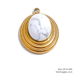 Gold pendant with a white stone on a white background