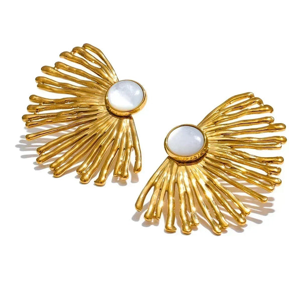 Gold earrings with white centers on a white background.
