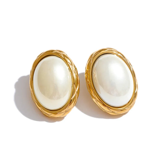 Pair of gold-framed earrings with white stones on a white background