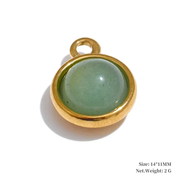 Green stone pendant with gold setting on a white background
