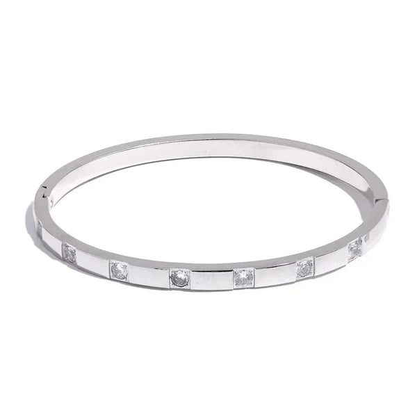 Sterling silver bangle bracelet with square set clear stones, minimalist jewelry design