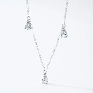 Silver necklace with teardrop-shaped pendants on a white background
