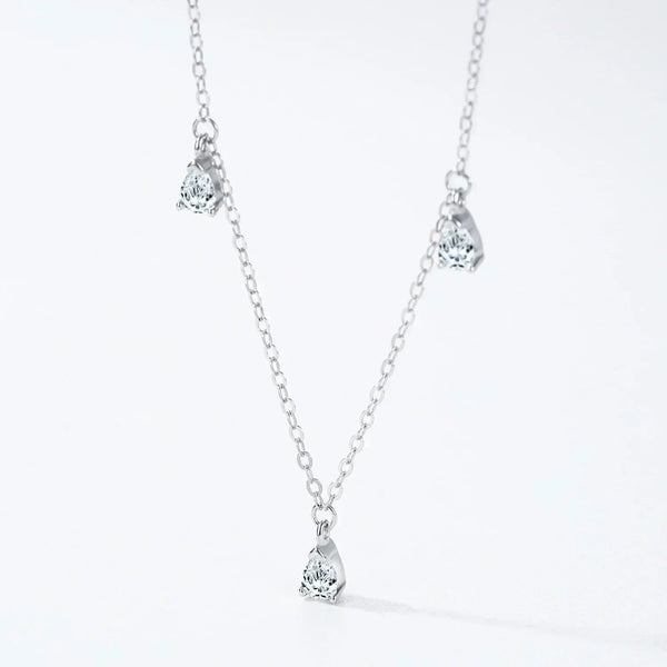 Silver necklace with teardrop-shaped pendants on a white background