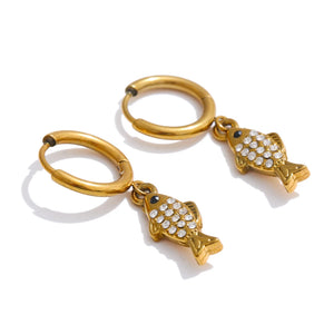 Gold fish-shaped keychains with rhinestone details on a white background