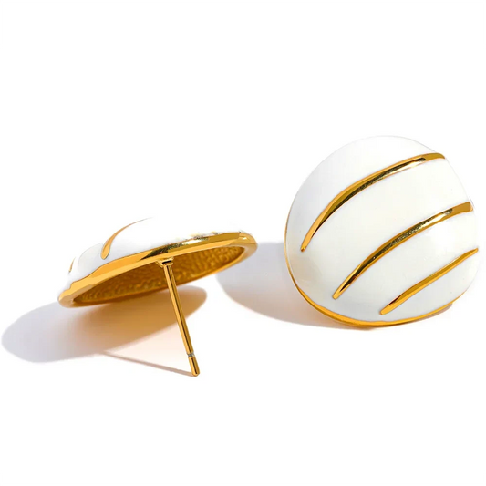 White spherical earrings with gold accents on a white background