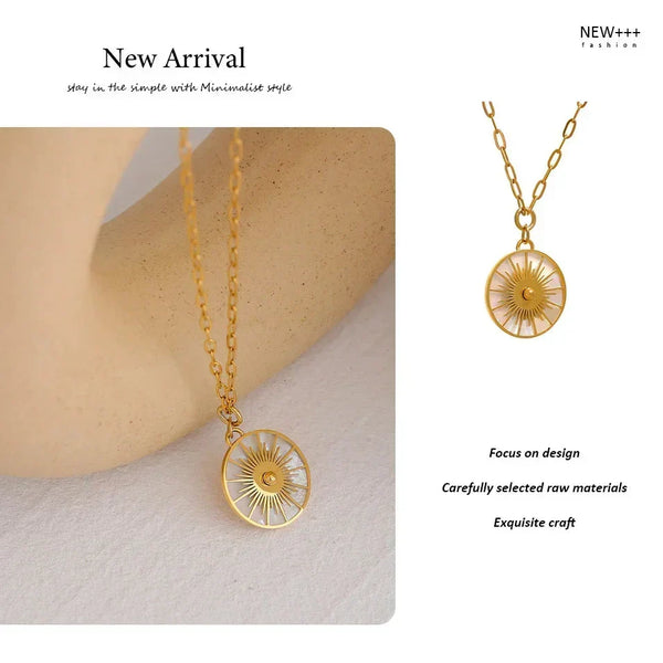 Gold necklace with a circular pendant on a neutral background, featuring the brand 'NEW++'.