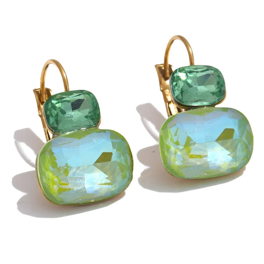 Pair of earrings with green and gold design on a white background