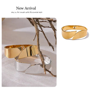 Gold and silver cuff bracelets on a neutral background with 'New Arrival' text.