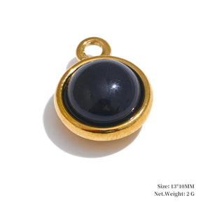 Gold pendant with a black gemstone on a white background