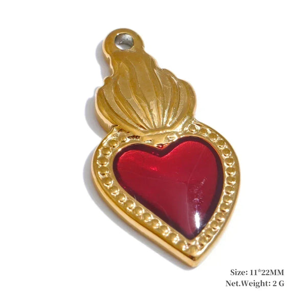 Gold heart-shaped pendant with a red center on a white background
