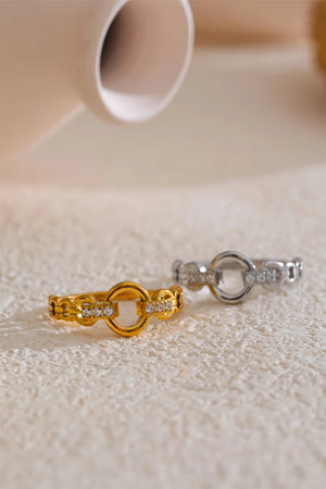 Gold and silver rings with diamond accents on a textured surface