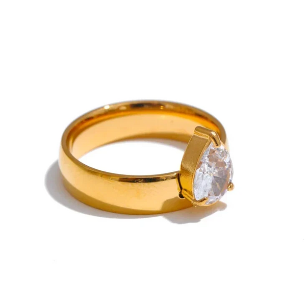 Gold ring with a diamond on a white background
