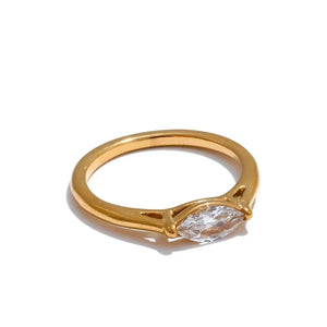 Gold ring with a diamond on a white background