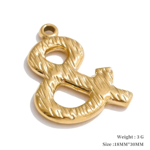 Gold ampersand symbol pendant on a white background