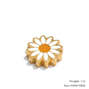 Gold flower-shaped object with a white center on a white background