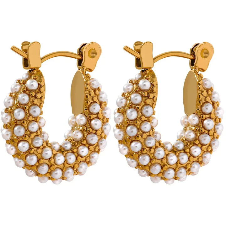 Gold hoop earrings with pearl accents on a white background