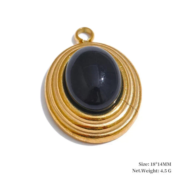 Gold pendant with a black stone on a white background