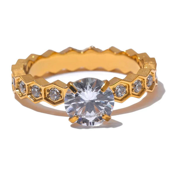 Gold ring with a large diamond and smaller diamonds on a white background