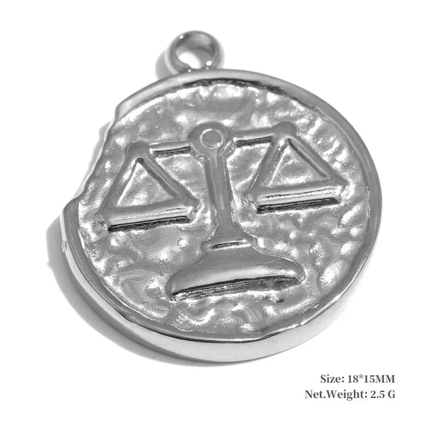 Silver pendant with a textured surface and a central design resembling scales on a white background.
