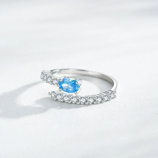 Silver ring with a blue gemstone on a white background