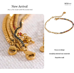 Gold-plated chain bracelets with multicolored gemstone accents displayed on white stand