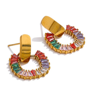 Gold hoop earrings with colorful gemstones on a white background
