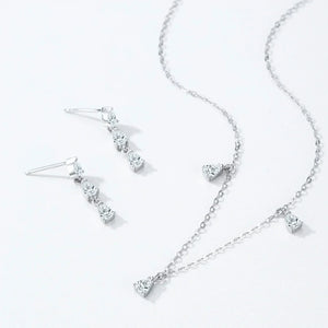 Silver necklace and earrings set on a white background