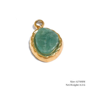 Gold pendant with a green stone on a white background