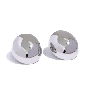 Pair of polished oval silver stud earrings on white background